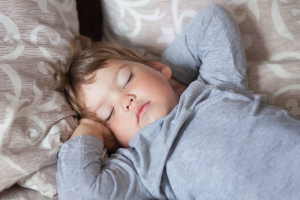 istock Adorable little girl sleeping in the bed. 869844732