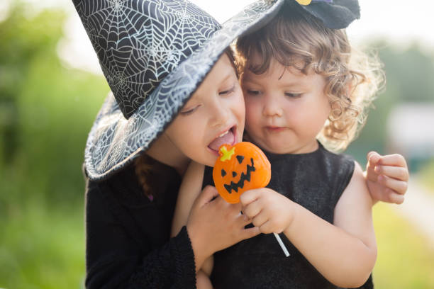 istock Two little sisters dressed like witches, trick or treat. 869844780