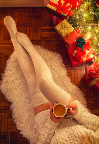 istock Young Woman Drinking Hot Coffee on Christmas Night 869848786