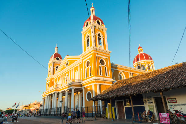 Granada, Nicaragua - November 29, 2011: People walk on Plaza de la Catedral, besides the landmark Cathedral of Granada in Granada, Nicaragua.