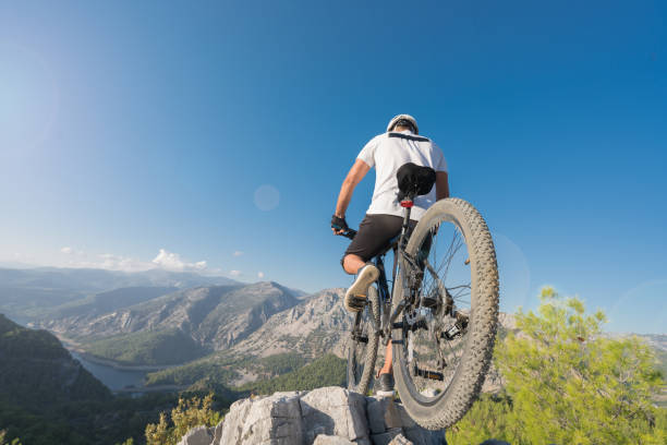 istock Mountain Biker Riding on a rocky hillside 869852094