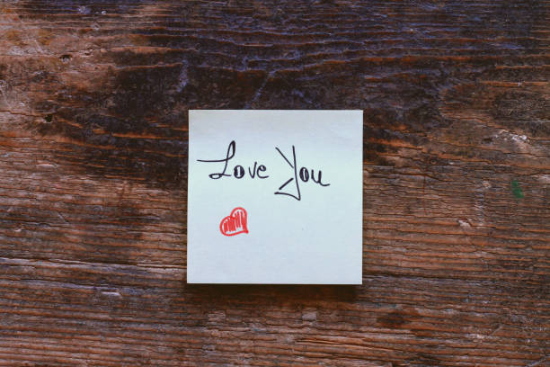istock Message Love You with small red heart on wooden table 869852948
