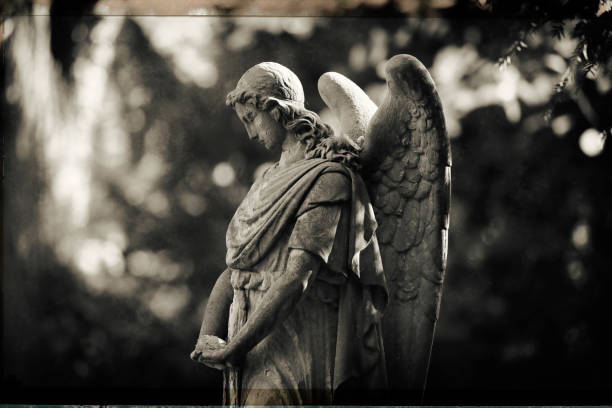 An angel lady statue in a Graveyard in winter