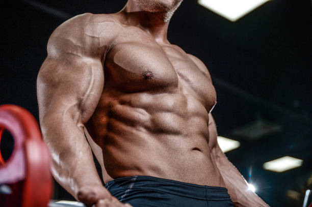 istock Handsome model young man training arms in gym 869856138