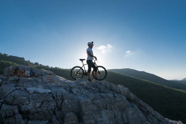 istock Mountain Biker standing  on a rocky hillside 869858652