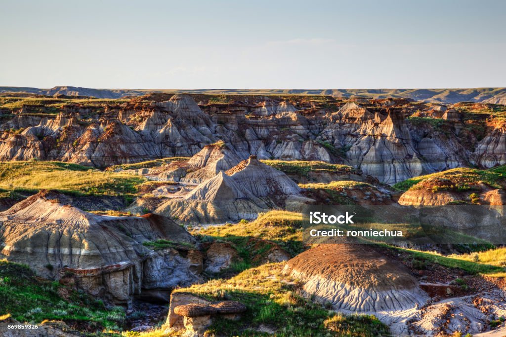 Badlands of Dinosaur Provincial Park in Alberta, Canada Sun setting over Dinosaur Provincial Park, a UNESCO World Heritage Site in Alberta, Canada. The Alberta badlands is well known for being one of the richest dinosaur fossil locales in the world. Badlands Stock Photo