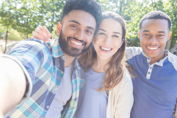 istock Three college buddies take selfie together outside 869862482