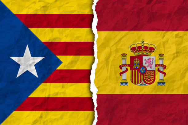istock flags of spain and catalonia on torn paper texture 869863134