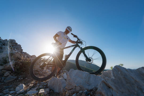 istock Mountain Biker Riding on a rocky hillside 869863154