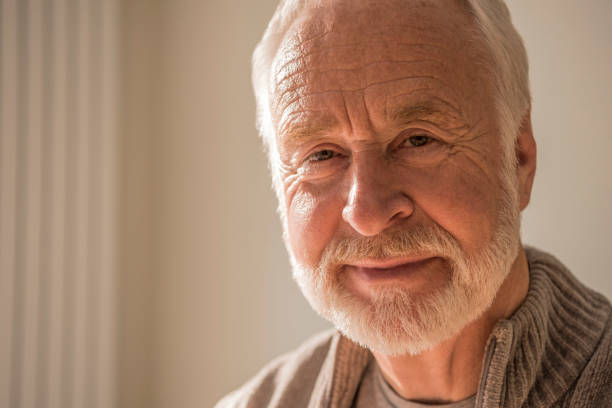 istock Portrait of contented senior man with beard looking towards camera 869863500