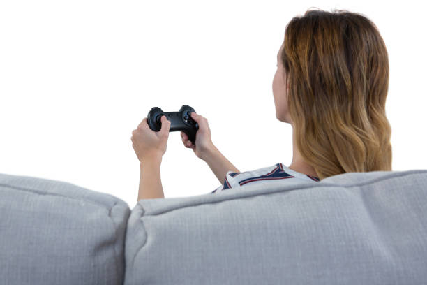 istock Woman playing video game against white background 869866432