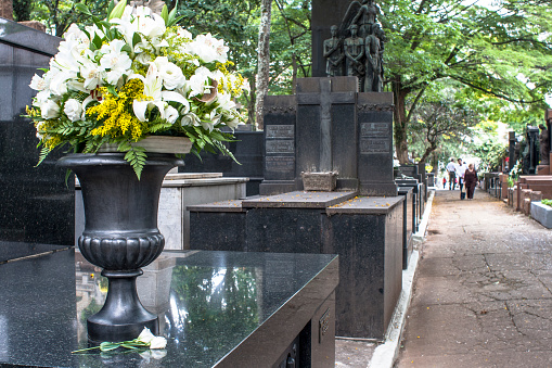 A grieving widow at a churchyard.