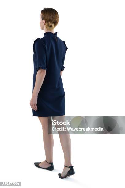 Female Executive Walking Against White Background Stock Photo - Download Image Now - Women, Rear View, White Background