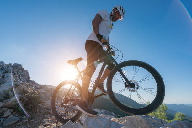 istock Mountain Biker Riding on a rocky hillside 869872982