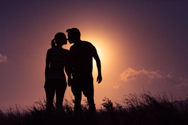 istock Couple kissing at sunset 869876016