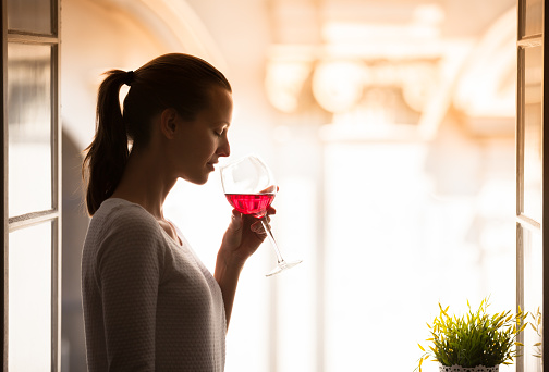 Woman siping on glass of red wine