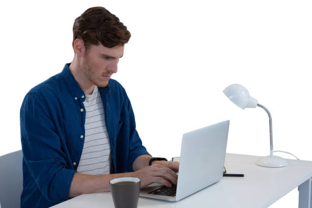 istock Male executive using laptop at desk 869878790