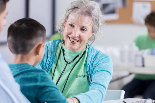 istock Confident doctor uses a stethoscope on young male patient 869879684