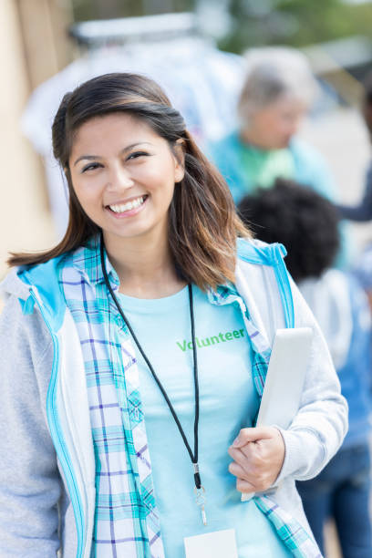 istock Cheerful woman volunteers during clothing drive 869879708