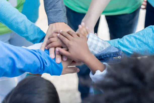 istock Diverse volunteers with hands together in unity 869879714