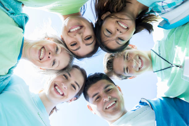 istock Diverse volunteers with heads together in a circle 869879724