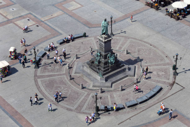 istock Adam Mickiewicz monument at the Main Market square with walking people. 869883136