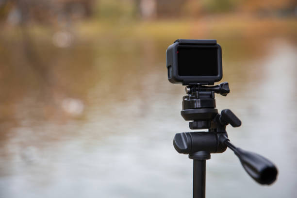 istock action camera on tripod beside lake. 869885876