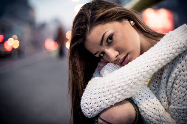 istock Depressed girl alone in the city 869892502
