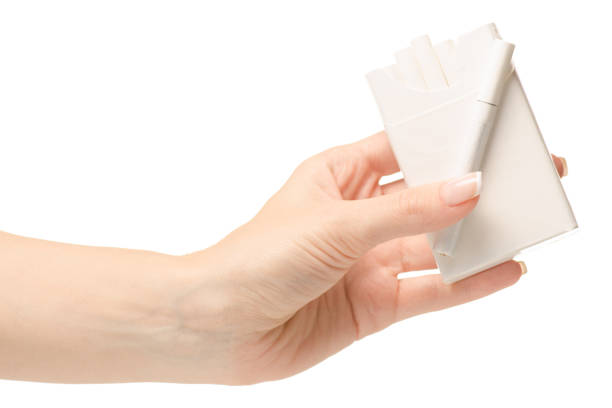 istock Female hand holding a pack of cigarettes 869896426