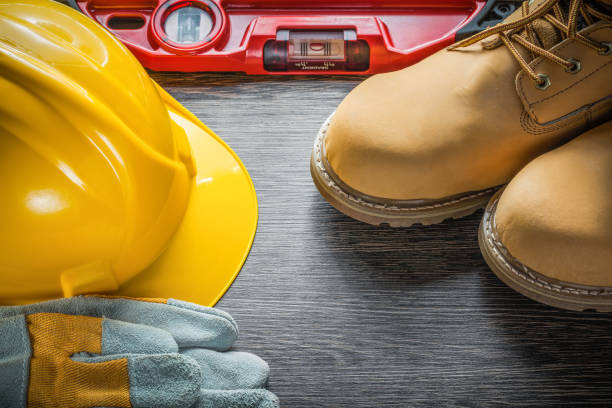 istock Construction level building helmet protective gloves boots on wo 869905530