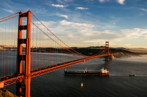istock Golden gate bridge with a tanker ship passing underneath 869905704