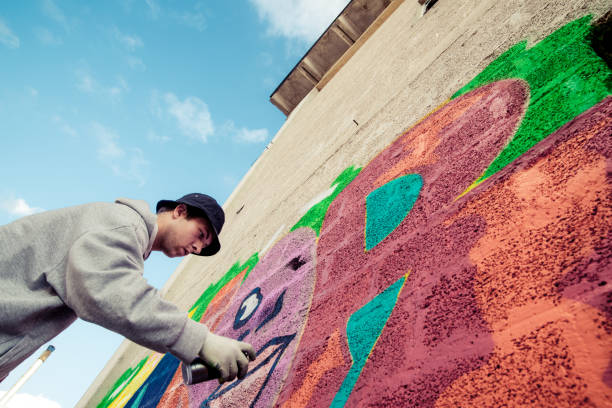 istock Graffiti Artist Spraying on the Wall 869911590