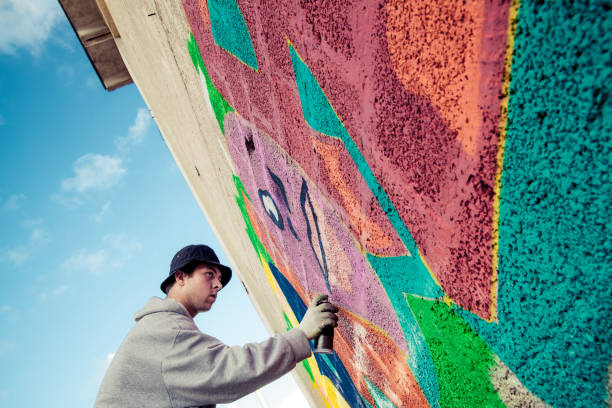 istock Graffiti Artist Spraying on the Wall 869911596