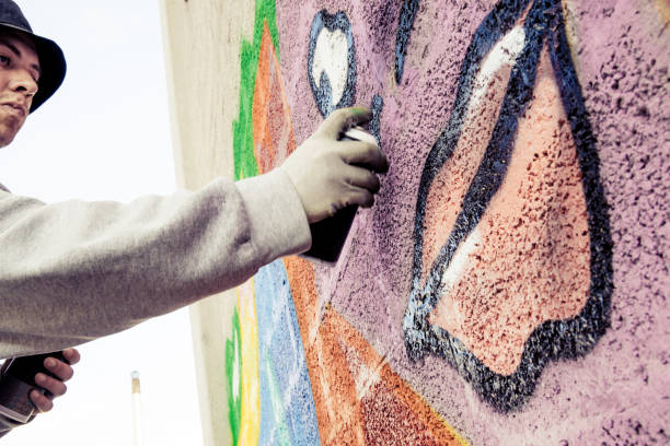 istock Graffiti Artist Spraying on the Wall 869911608