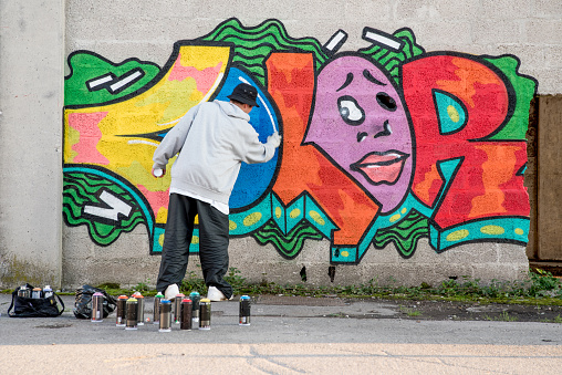 Brussels, Belgium – December 02, 2022: Colorful impression on an empty skateboard park with dense grafitti against an urban background
