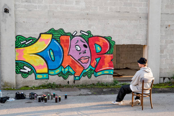 istock Young Artist Sitting next to Graffiti 869911648