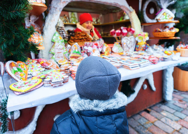 Riga, Latvia - December 28, 2016:Kid at the stall on Christmas Market at Dome Square in Riga Old Town in winter