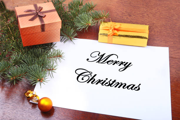 istock Christmas gift box on a wooden desktop with letter for copy space. 869918426