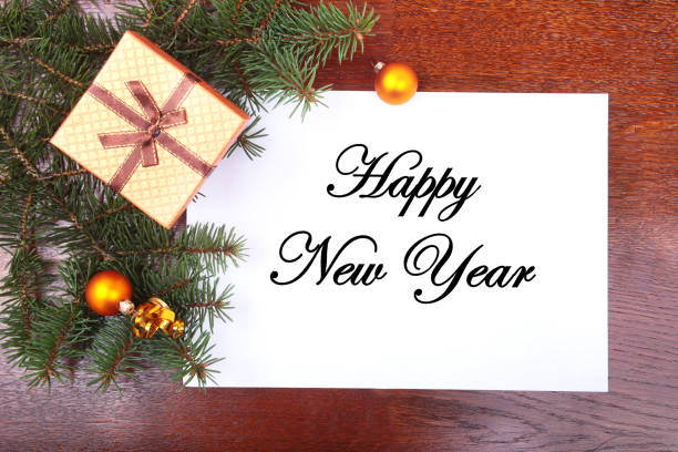 istock Christmas gift box on a wooden desktop with letter for copy space. 869918456