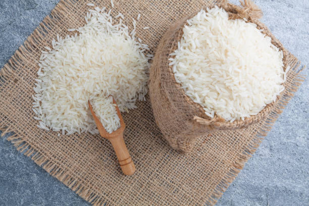 istock thai fragrant jasmine rice in a spoon with gold spike on Sack 869919550