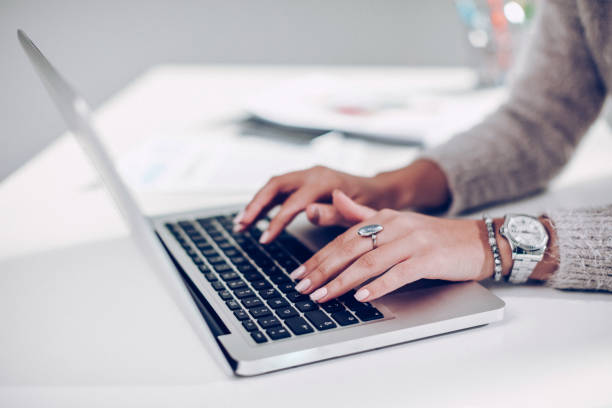istock Women hands typing on laptop keyboard 869925360