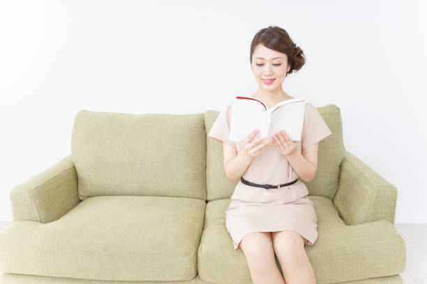 istock woman reading books in room 869939842
