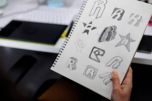 Hand Holding Notebook With Drew Brand Logo Creative Design Ideas