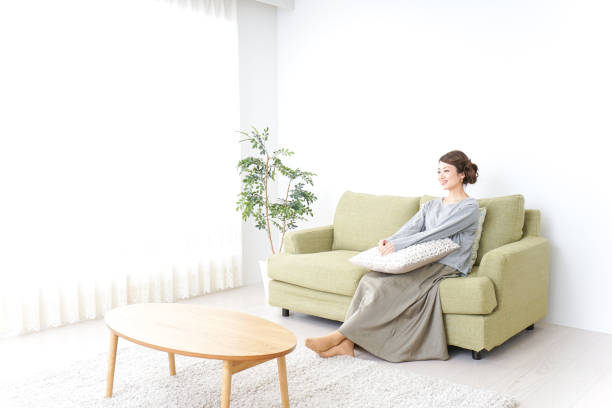 istock woman watching TV at home 869940464