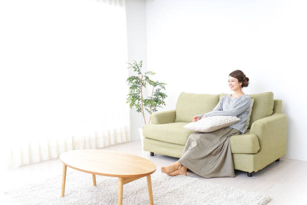 istock woman watching TV at home 869940474