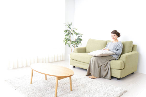 istock single woman being relaxed at home 869942940
