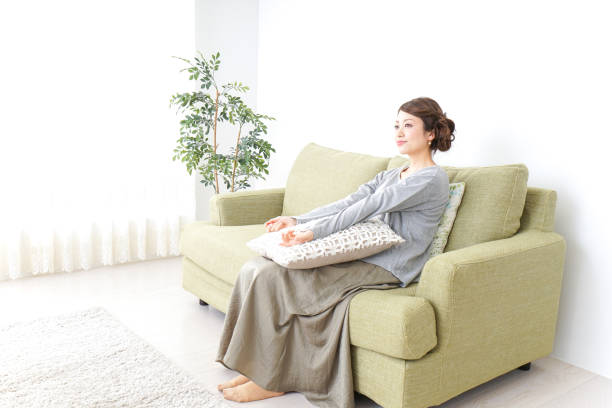 istock single woman being relaxed at home 869942942