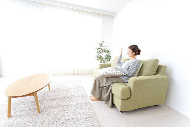 istock single woman being relaxed at home 869943140