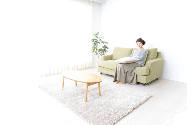 istock single woman being relaxed at home 869943146