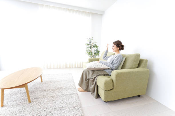 istock single woman being relaxed at home 869943148